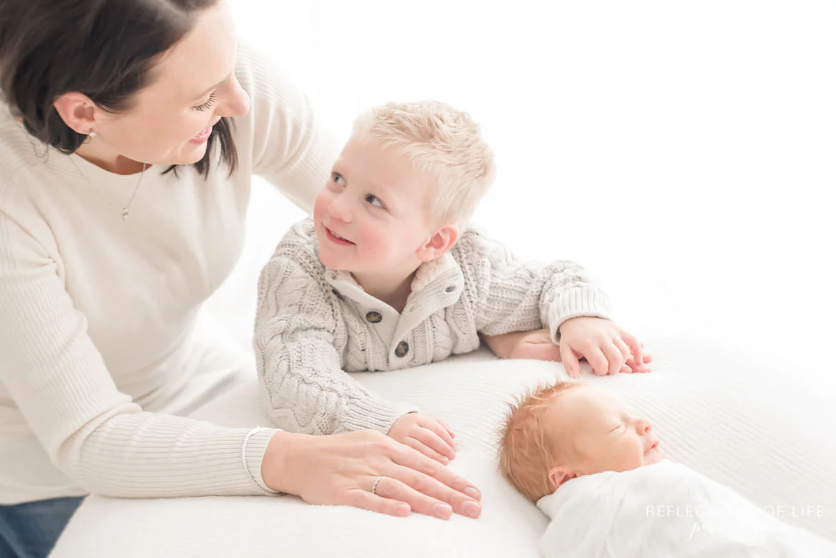 Little boy looking up at his mama for approval.jpg