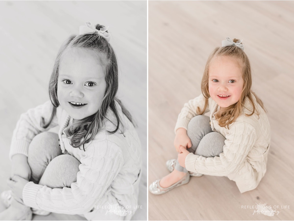 Cute little girl smiles at the camera black and white