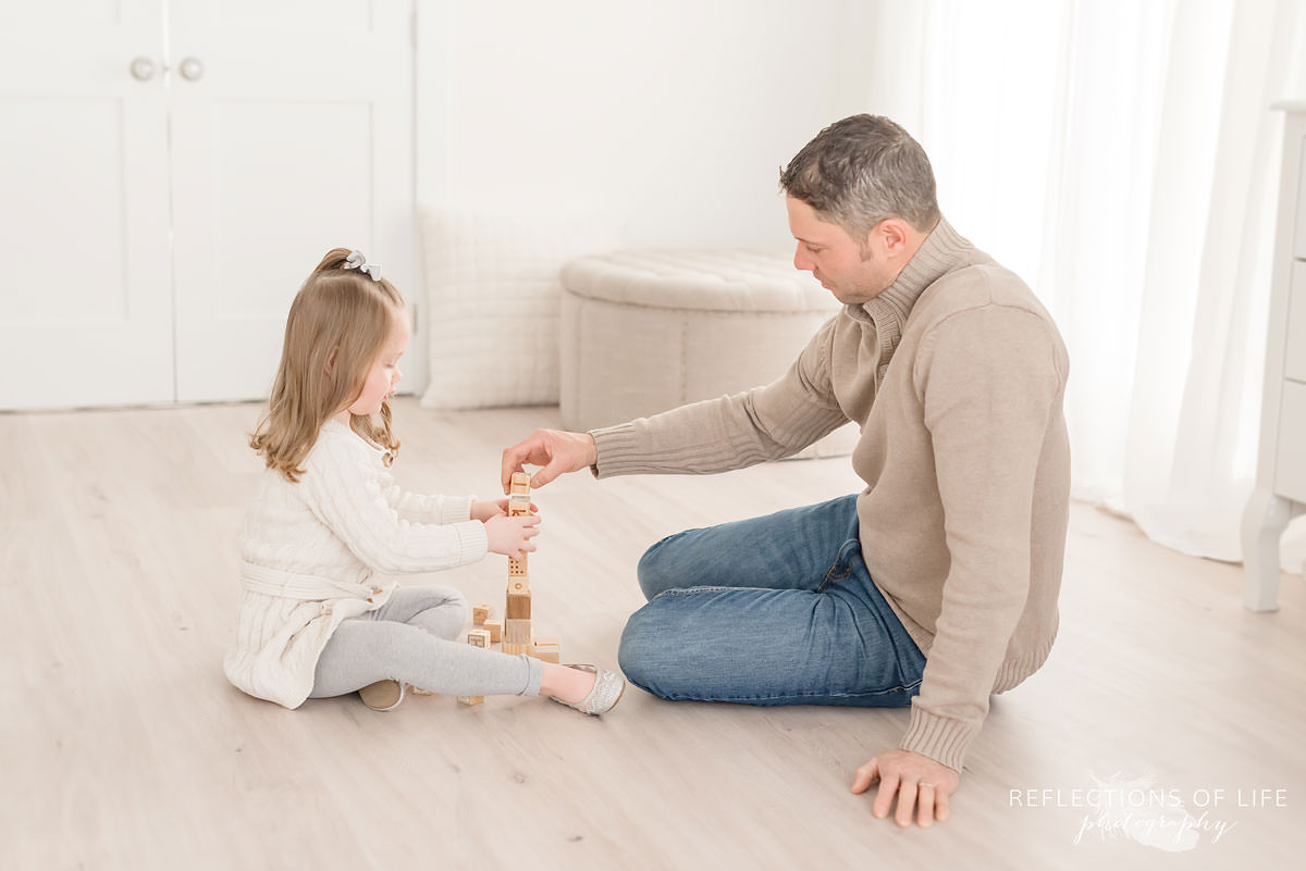 Father and daughter play with blocks in Ontario