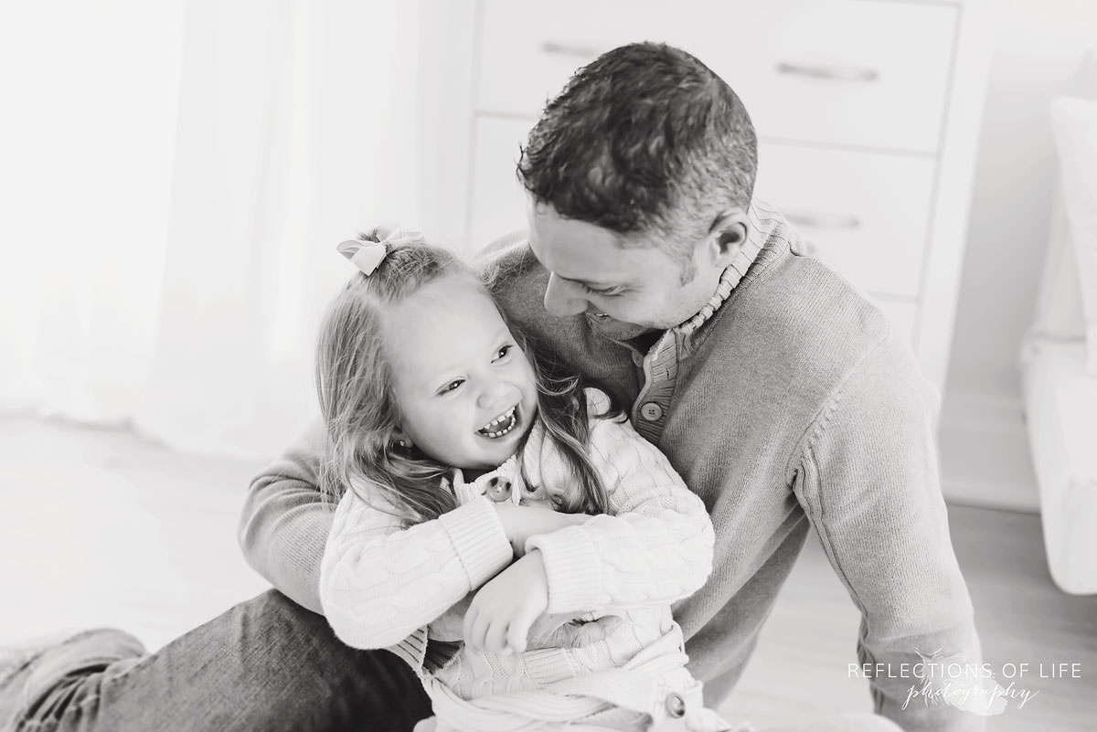 Father and daughter hugging black and white