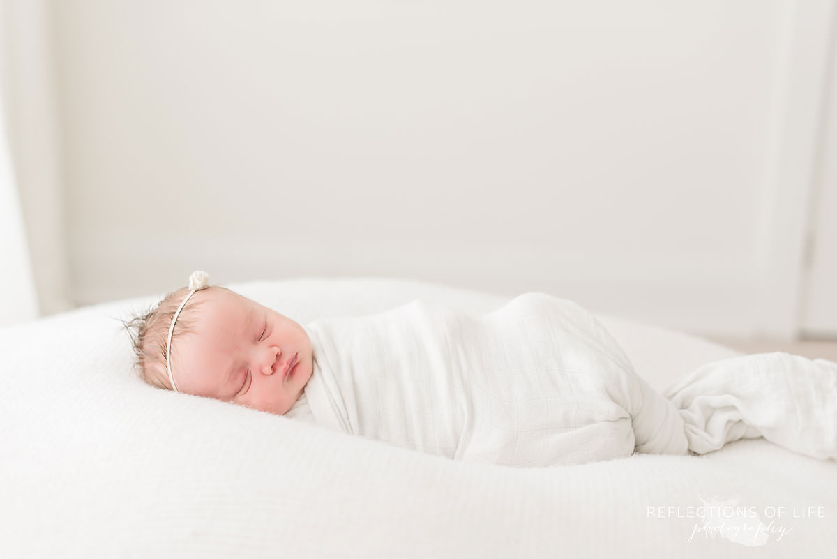 Baby sleeps in natural light studio