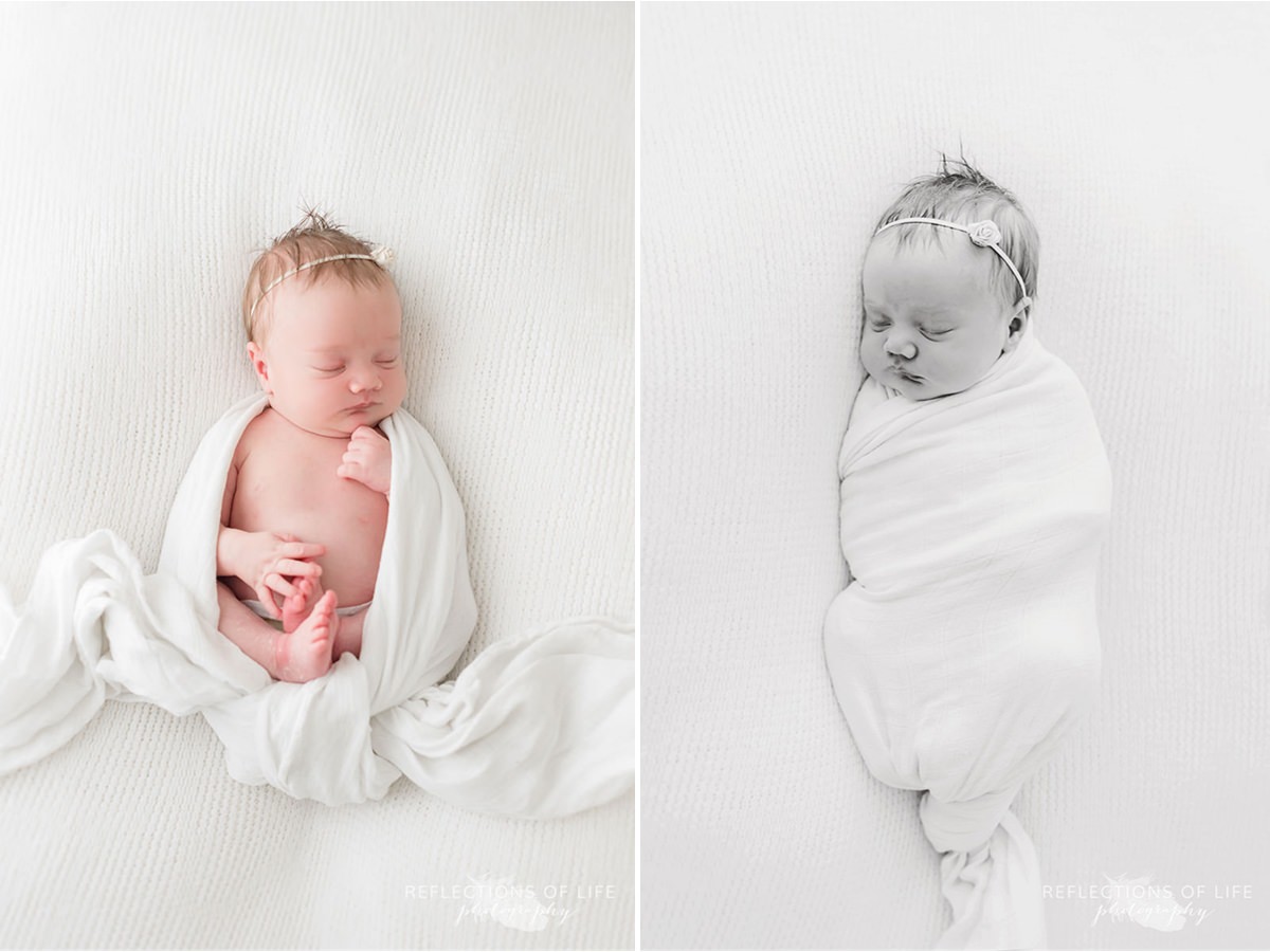 Baby swaddled in blanket sleeps black and white