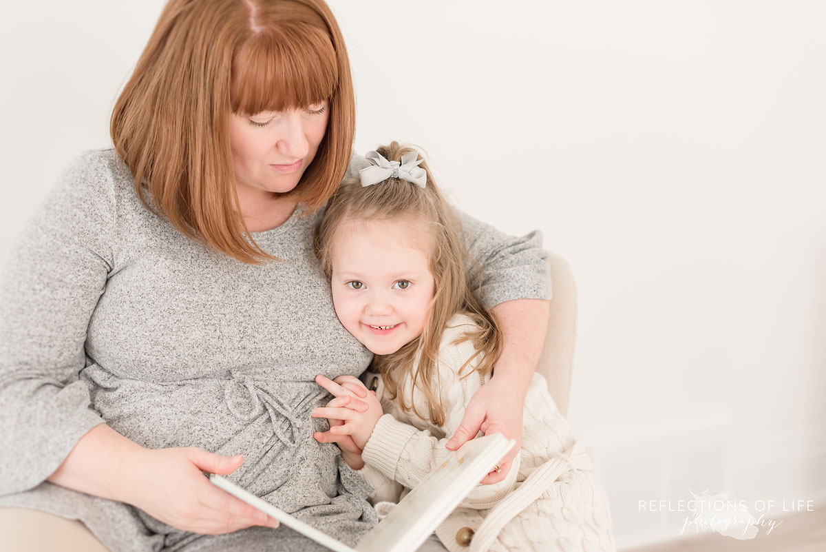 Mother and daughter read a book together in Niagara