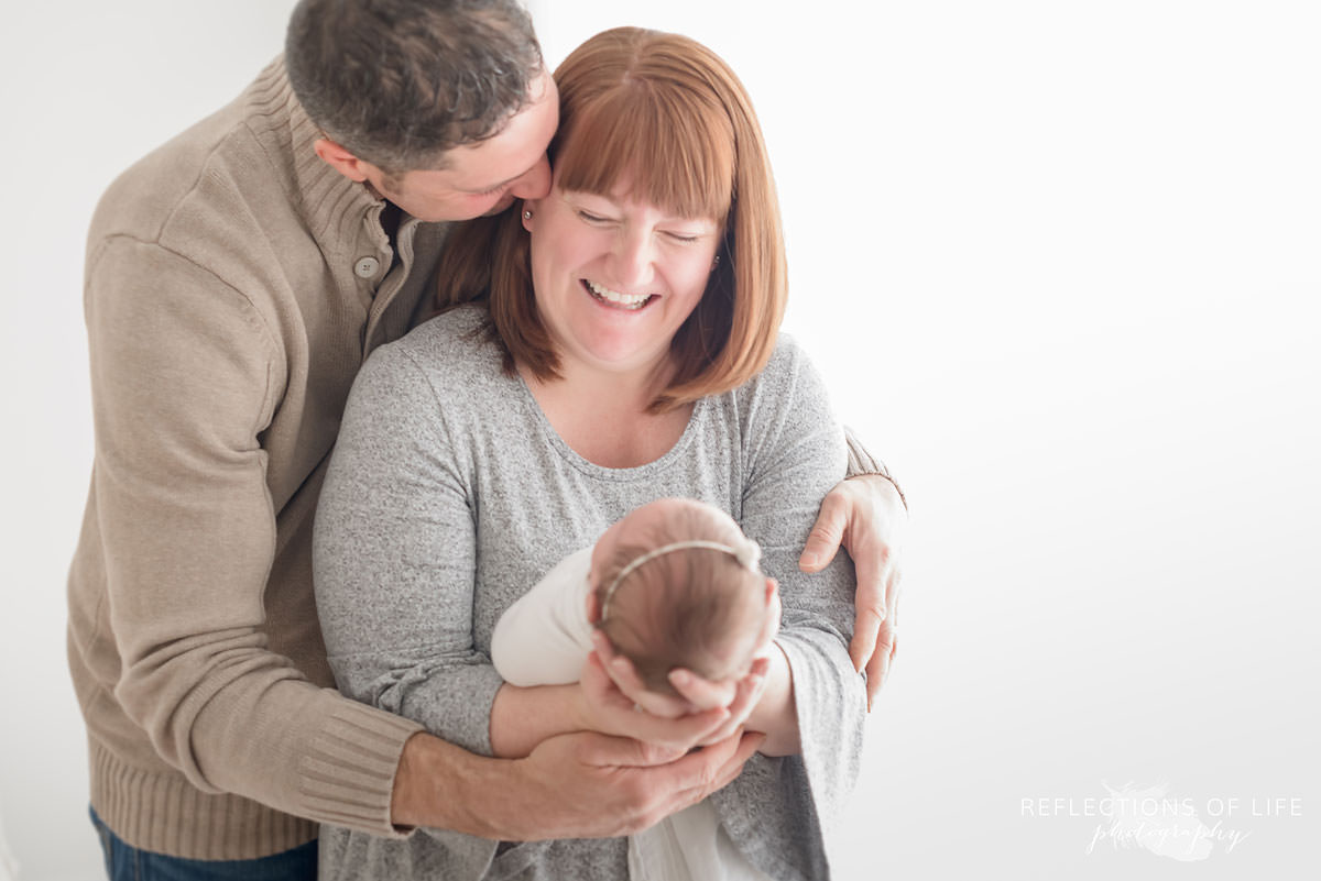 Husband kisses wife as she loves up her new baby in Grimsby