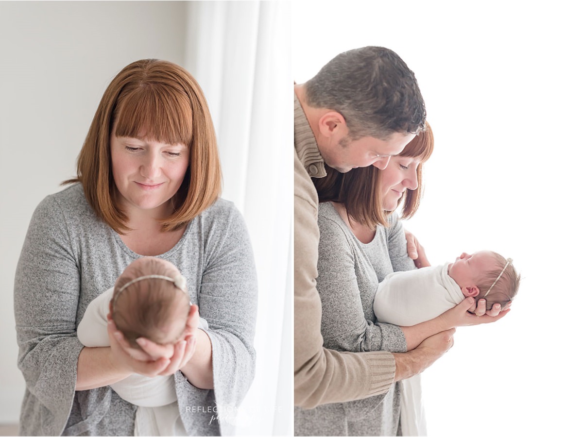 Parents and new born smiling at each other in Ontario