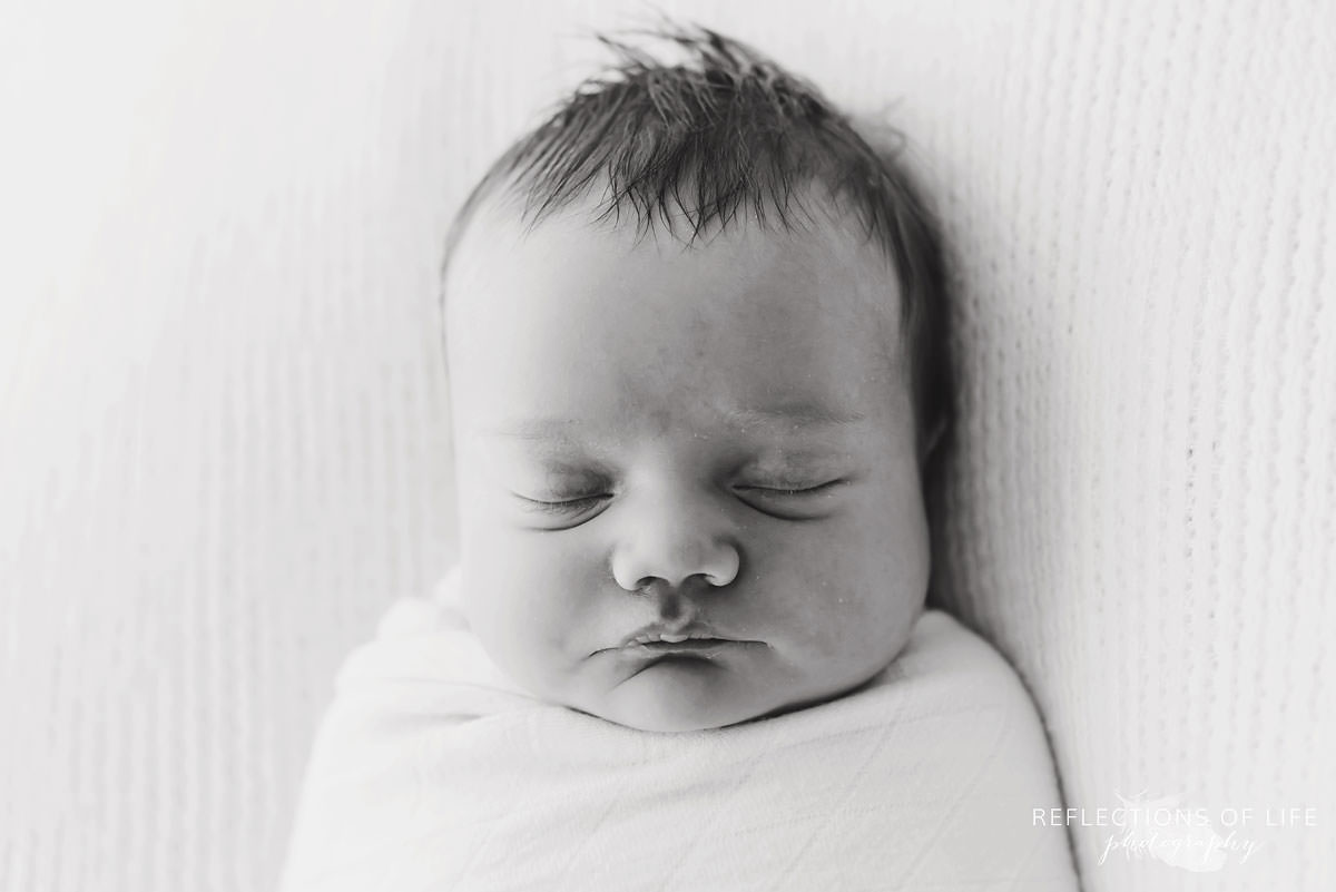 Sleeping baby black and white in natural light studio