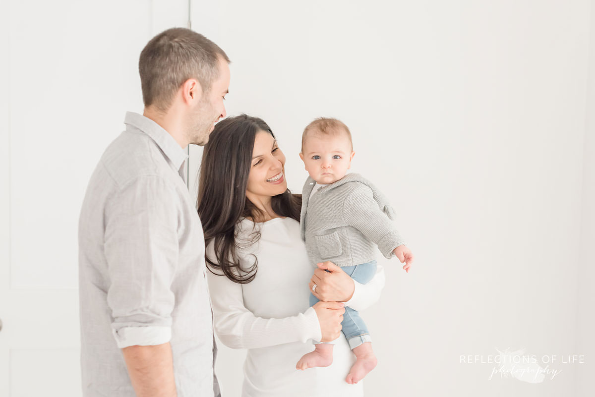 family of three in a natural light studio