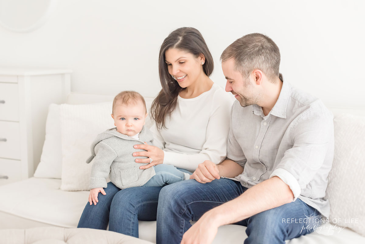family of three in natural light studio