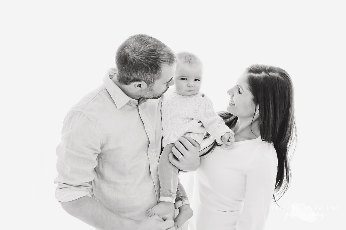 family of three are loving in black and white
