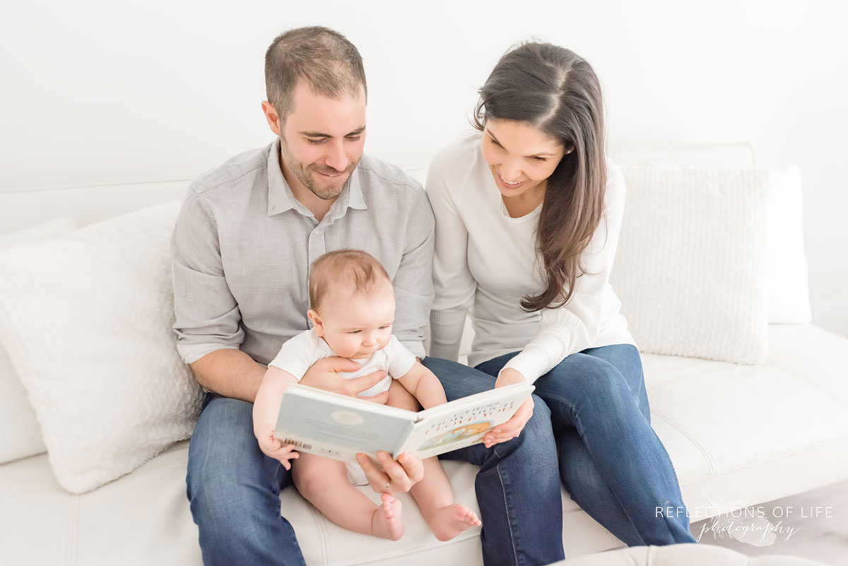 family of three read a book a book to baby