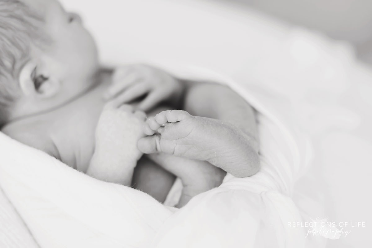 baby sleeping with it's foot in focus in niagara