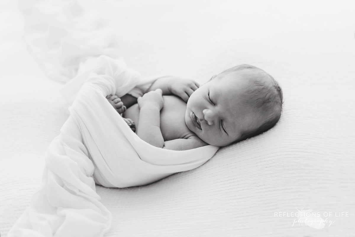 cozy baby sleeping in black and white