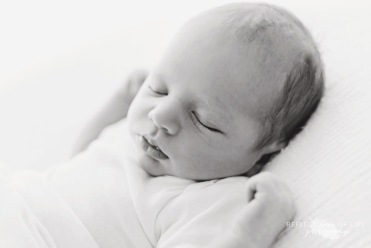 baby sleeps in black and white