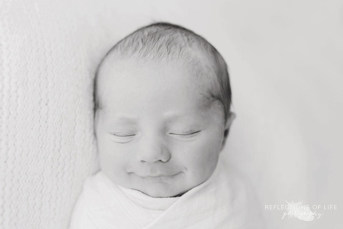 Baby smiling in black and white
