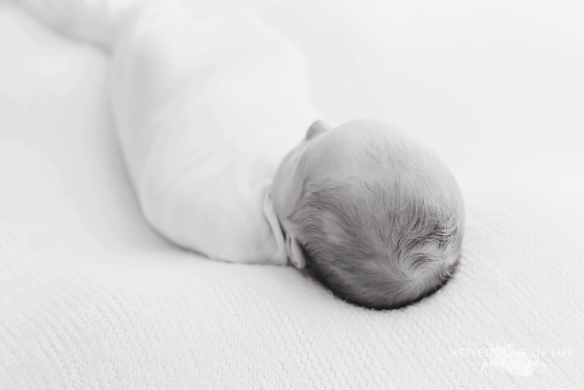 Cute baby sleeps in black and white 