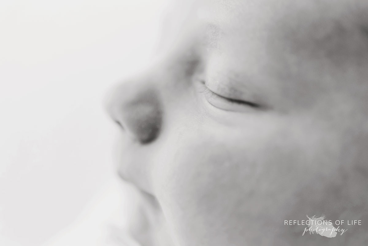 Close up of newborn baby's eyelashes in black and white