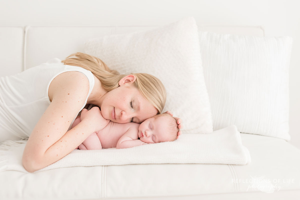 mother lays on son as he sleeps in ontario