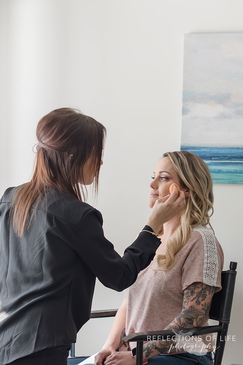 Beautiful woman gets her makeup done in natural light