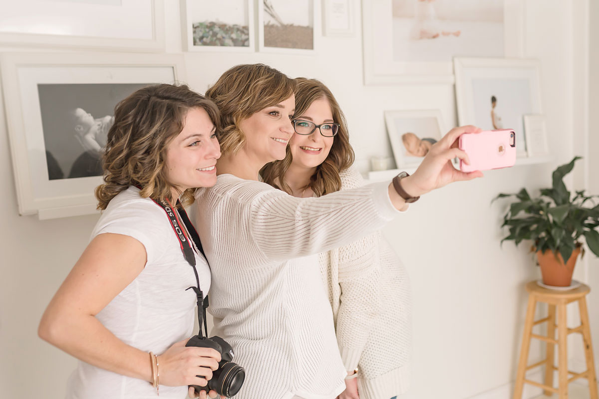 three newborn photographers share a selfie