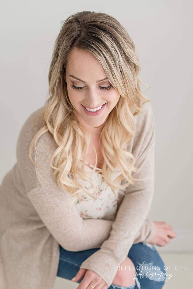 Gorgeous image of young mom looking down and smiling