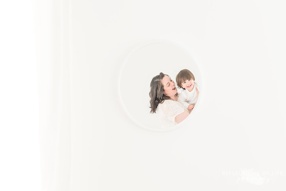 Natural light photography of mom and baby in mirror