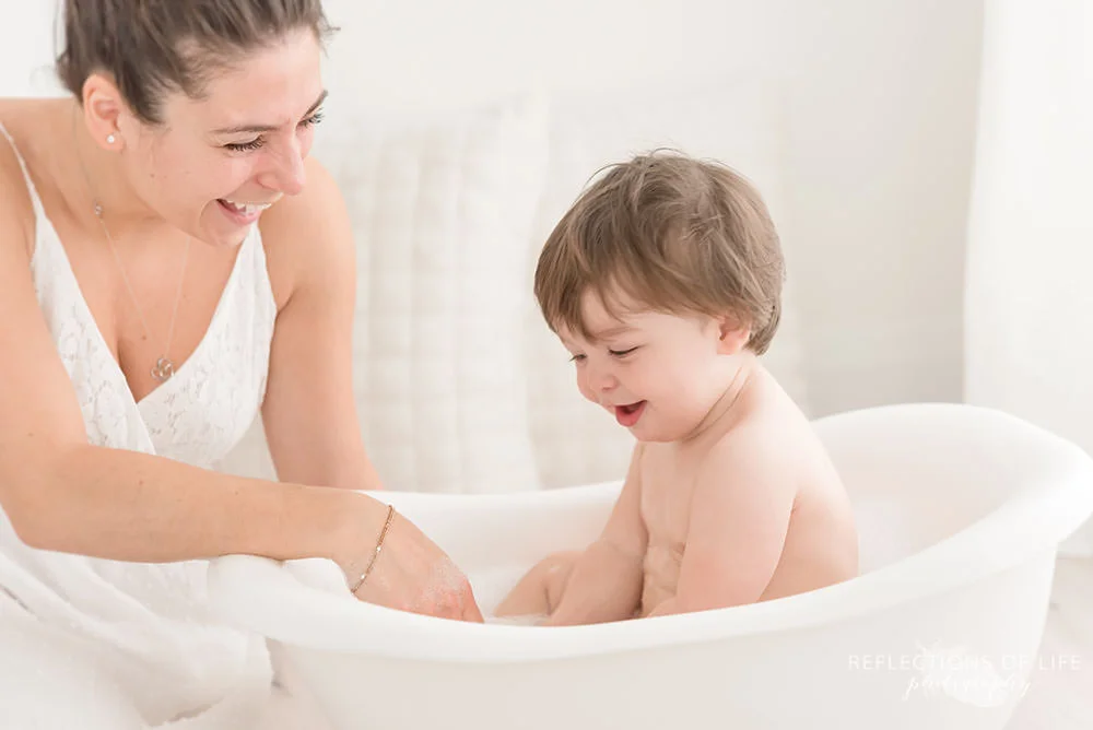 mama and son laugh whole son is in the bath