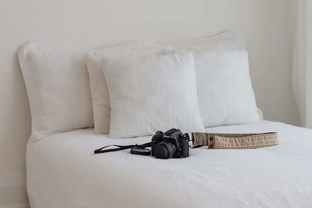 nikon camera in white bed in natural light studio