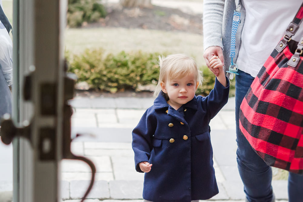 pretty little girl enters the home of the event