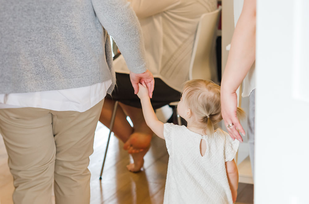 mama leads her little girl into the studio