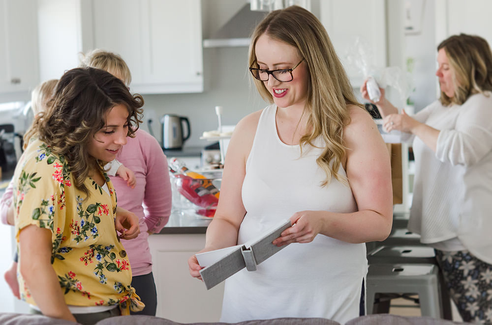 kayla is shown a book in kitchen of natural light studio