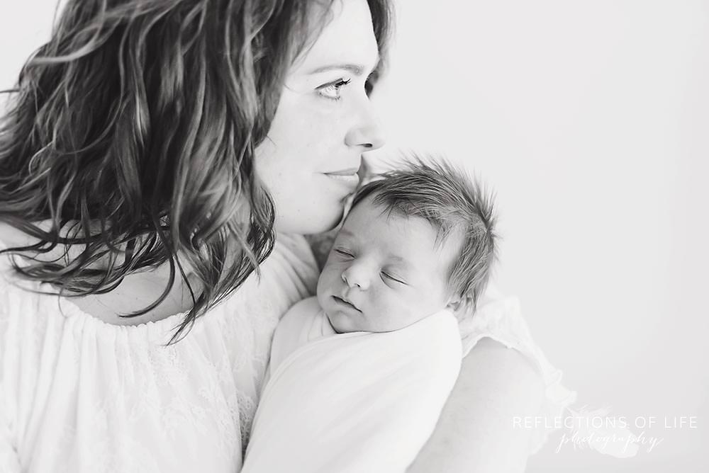 mother holds her baby in black and white close up.jpg