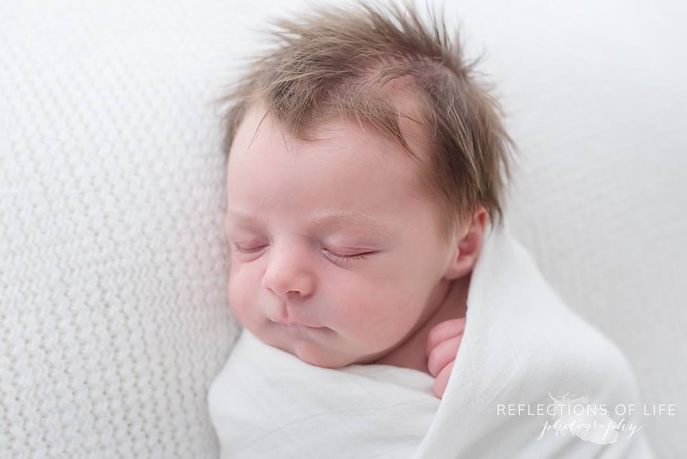 baby sleeps in natural light studio close up