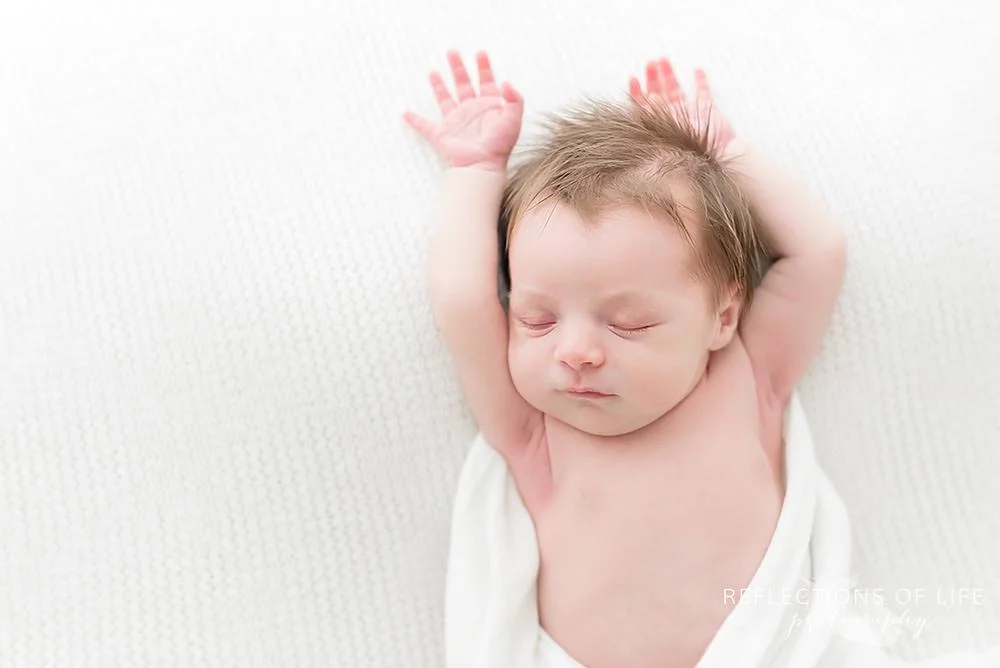 baby stretches in natural light studio.jpg