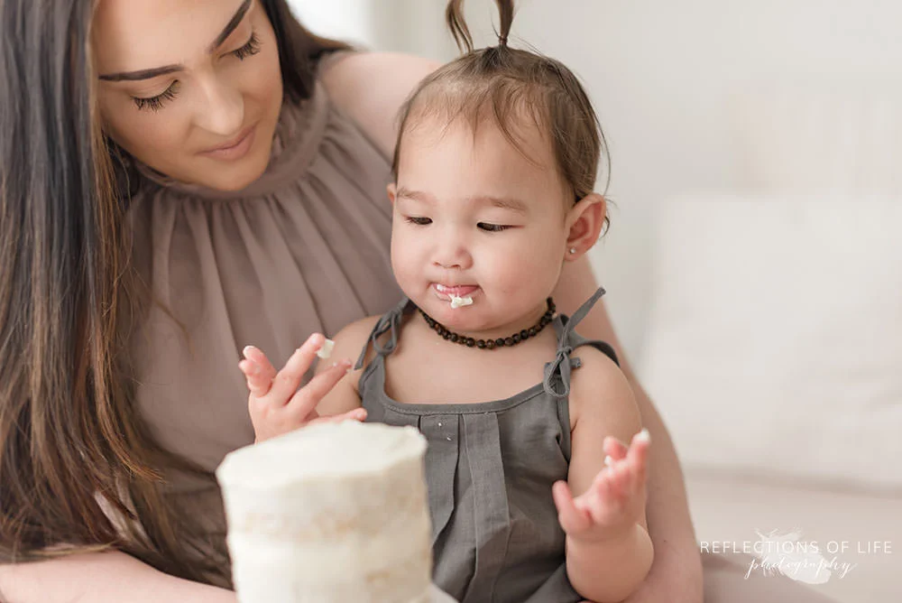 baby licks her lips after eating icing in grimsby