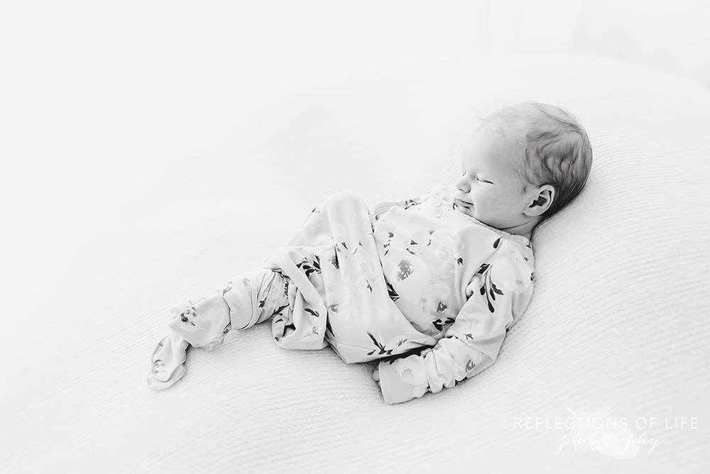 little girl shows slight smile in black and white