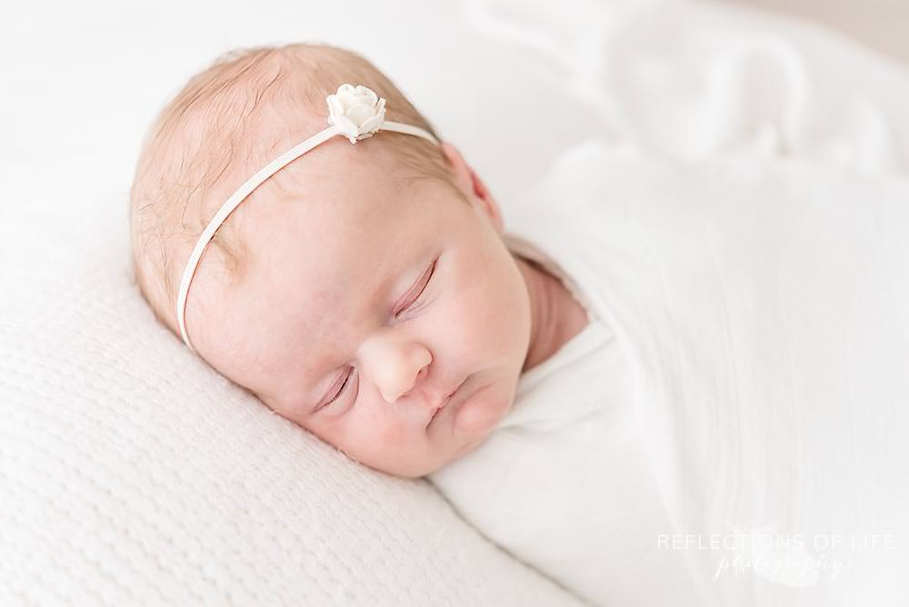 baby sleeping on bean bag in natural light studio