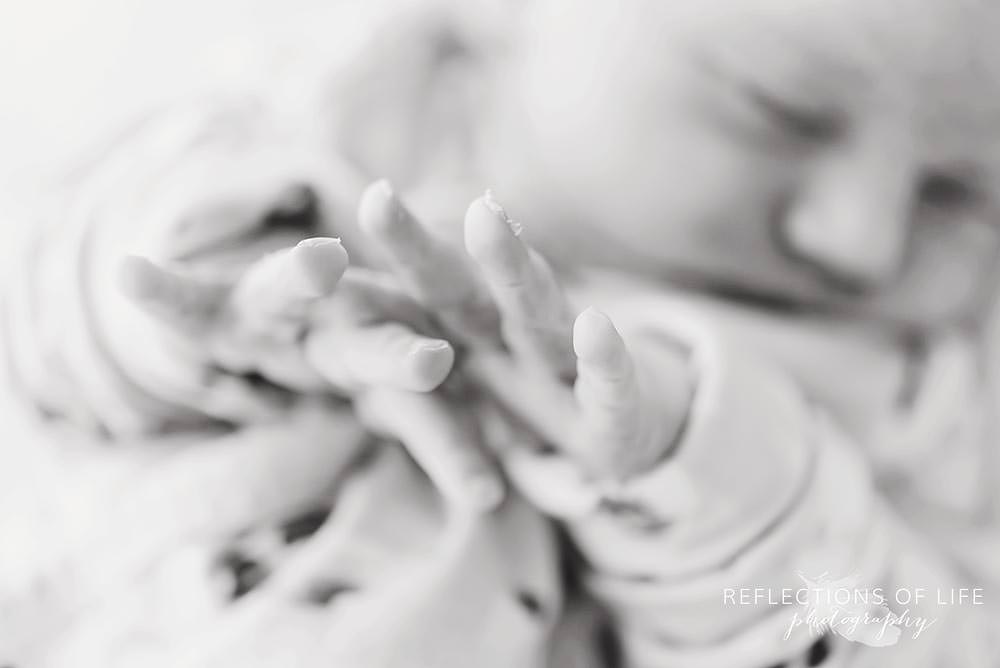 close up of babies stretching fingers