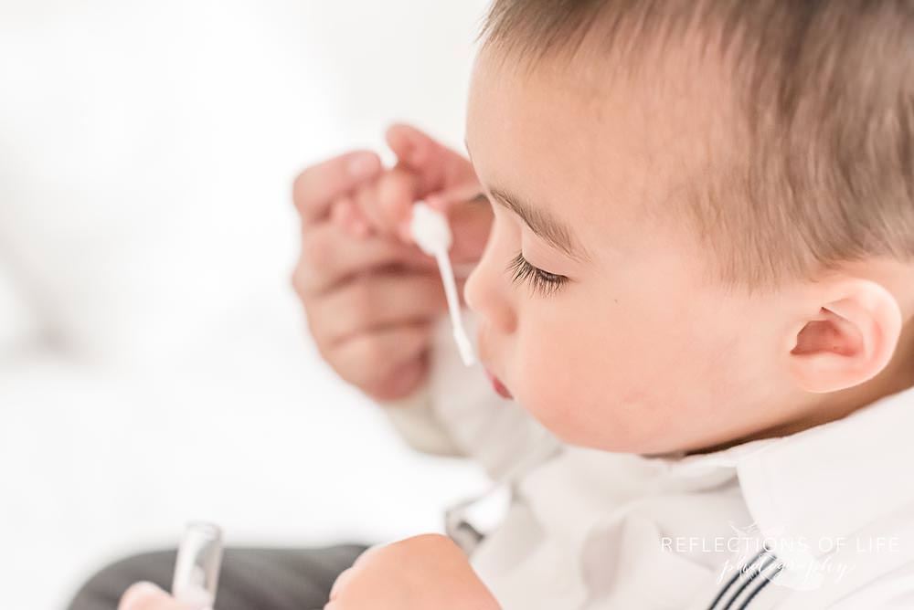 little boy blows bubbles with a closeup of his eyelashes