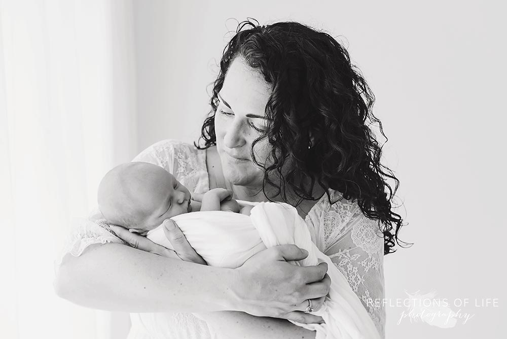 mama looks at her baby with love in black and white