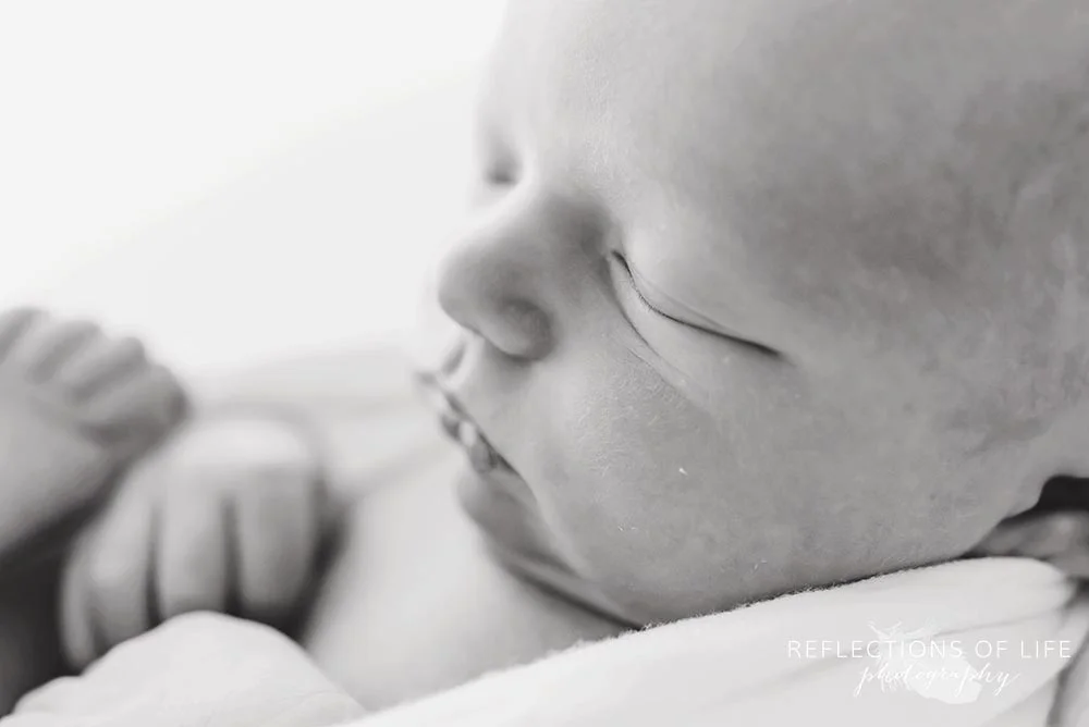 close up of baby's sleeping face in black and white