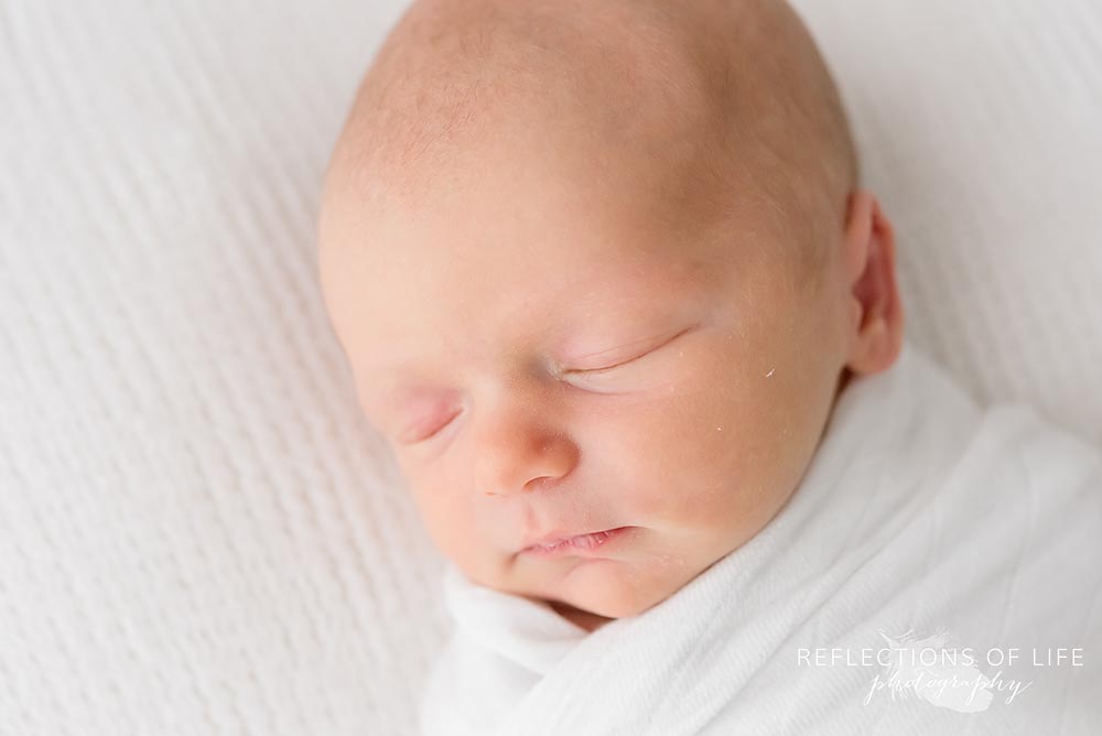 baby sleeps in natural light studio close up