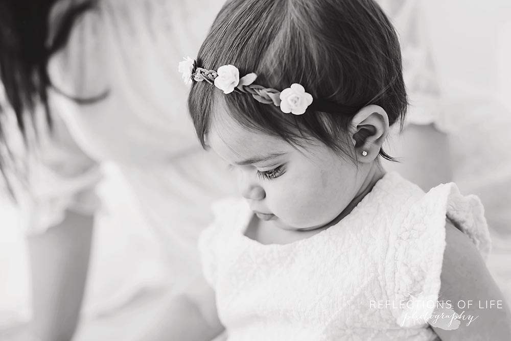 profile of baby's flower head band in black and white`