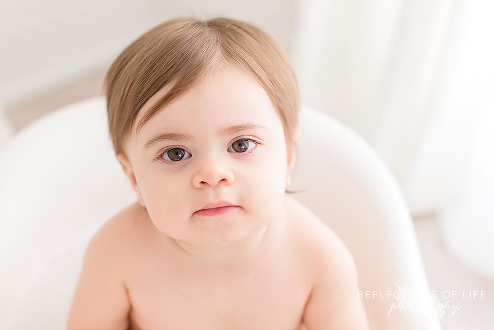 close up of baby looking at the camera in natural light studio