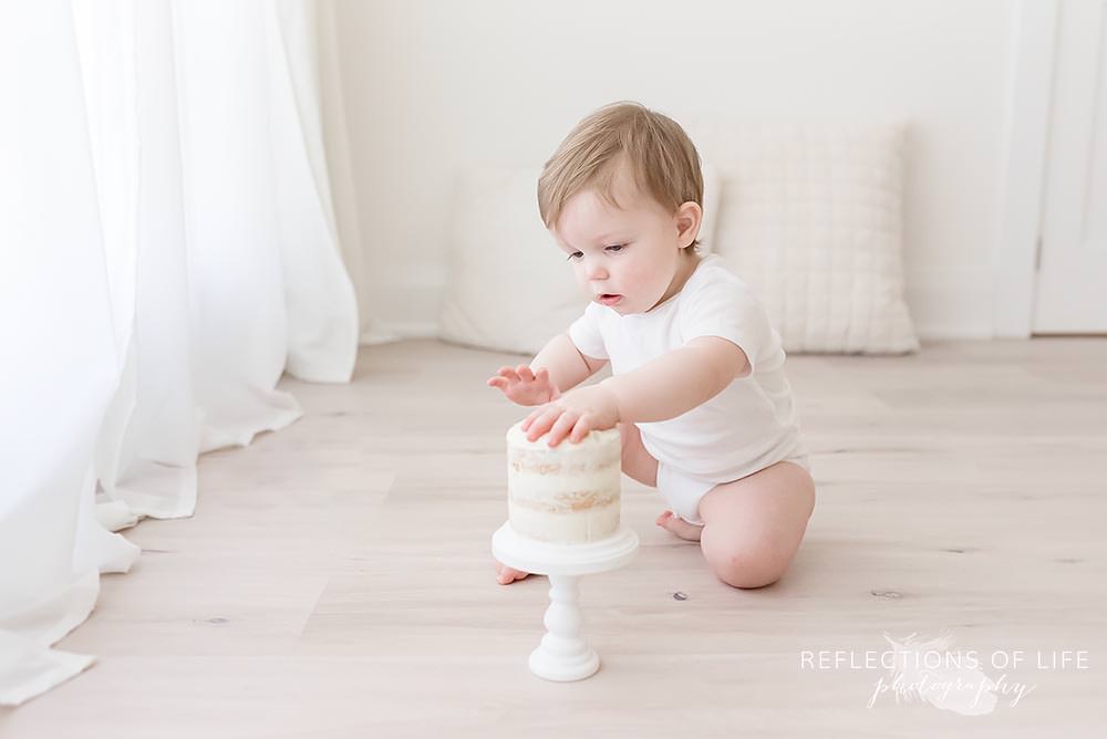 little boy plays with his cake