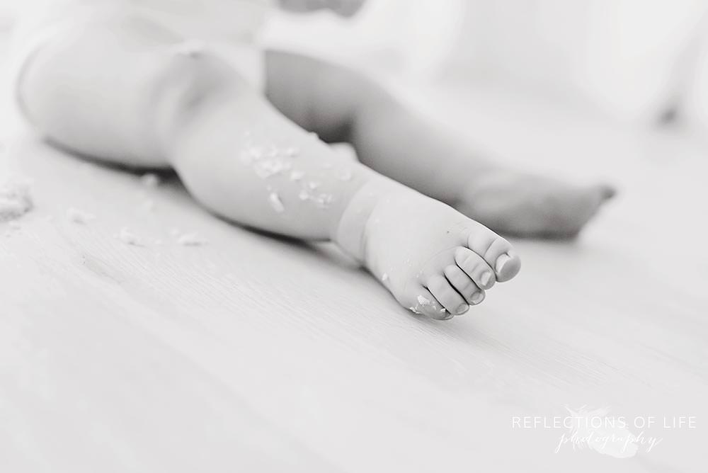 close up of baby's legs in black and white