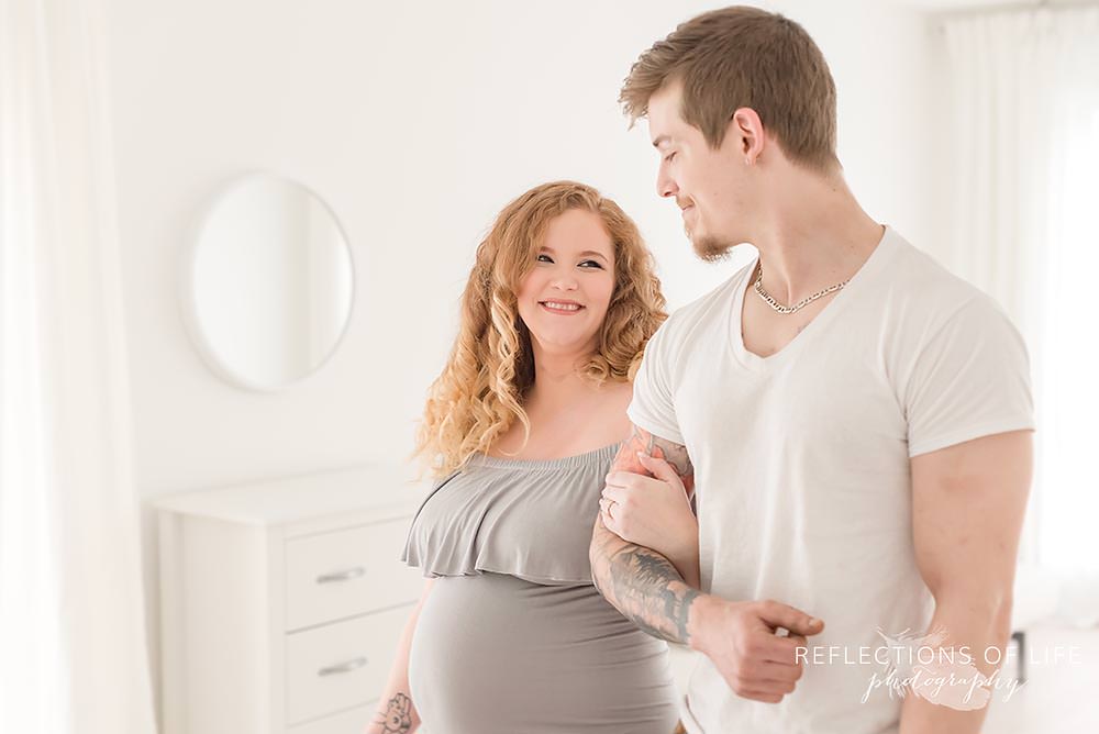 pregnant woman looks at her husband and smiles in grimsby