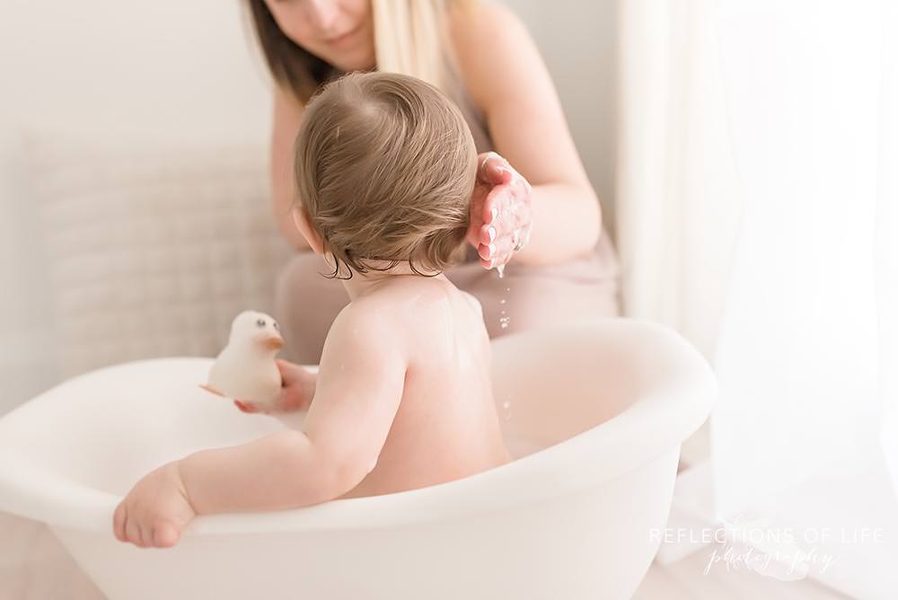 Mama baths baby in natural light studio Niagara Ontario.jpg