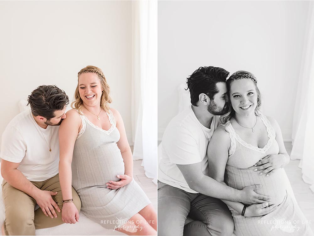 pregnant couple laughing and looking at the camera Niagara Ontario