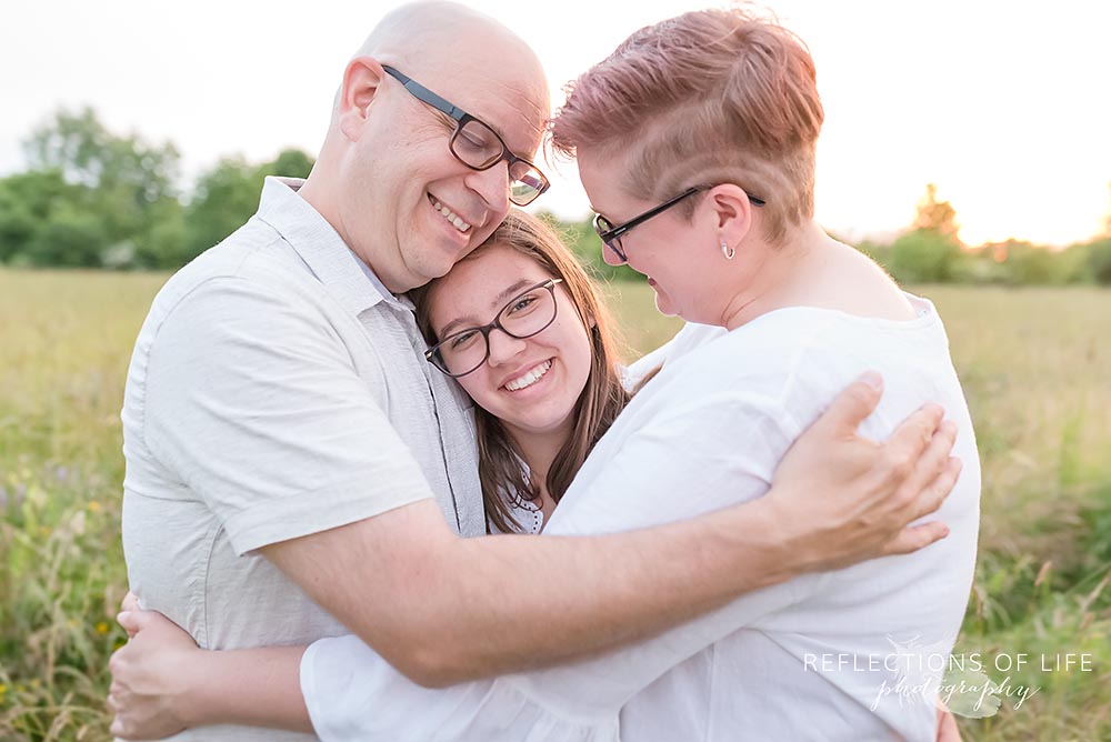 Family hugging professional family photographer Grimsby Ontario