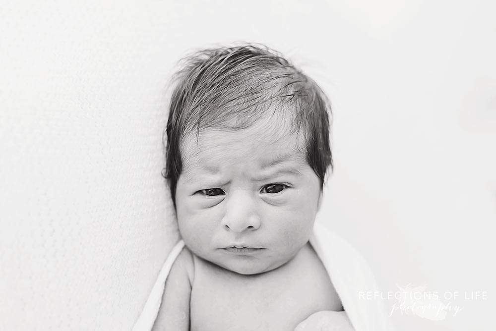 Newborn baby boy with funny eyebrow expression.jpg